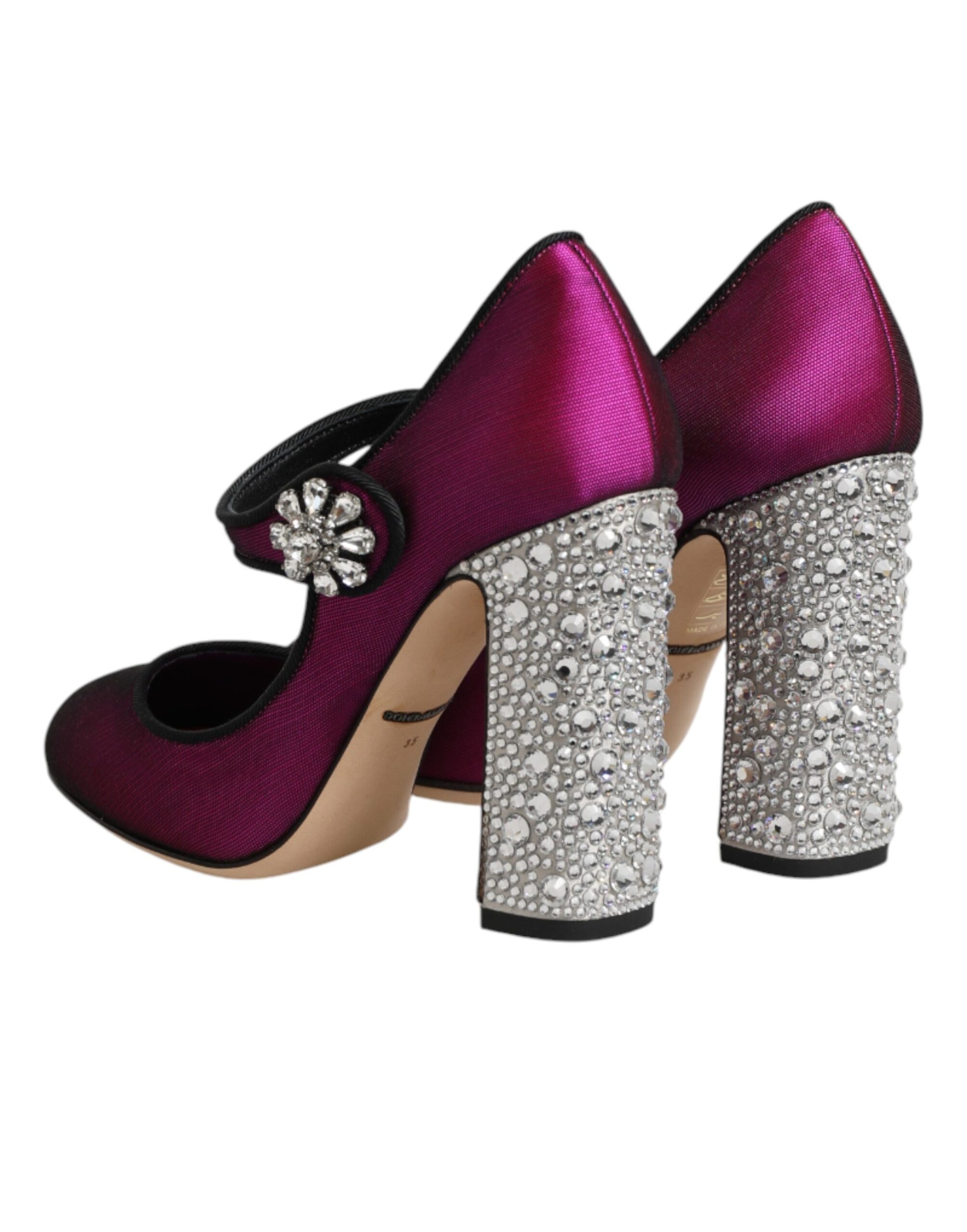 Pair of high heel shoes with rhinestones and a bow on top