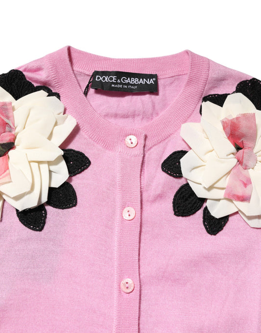 Pink sweater with floral embellishments on front