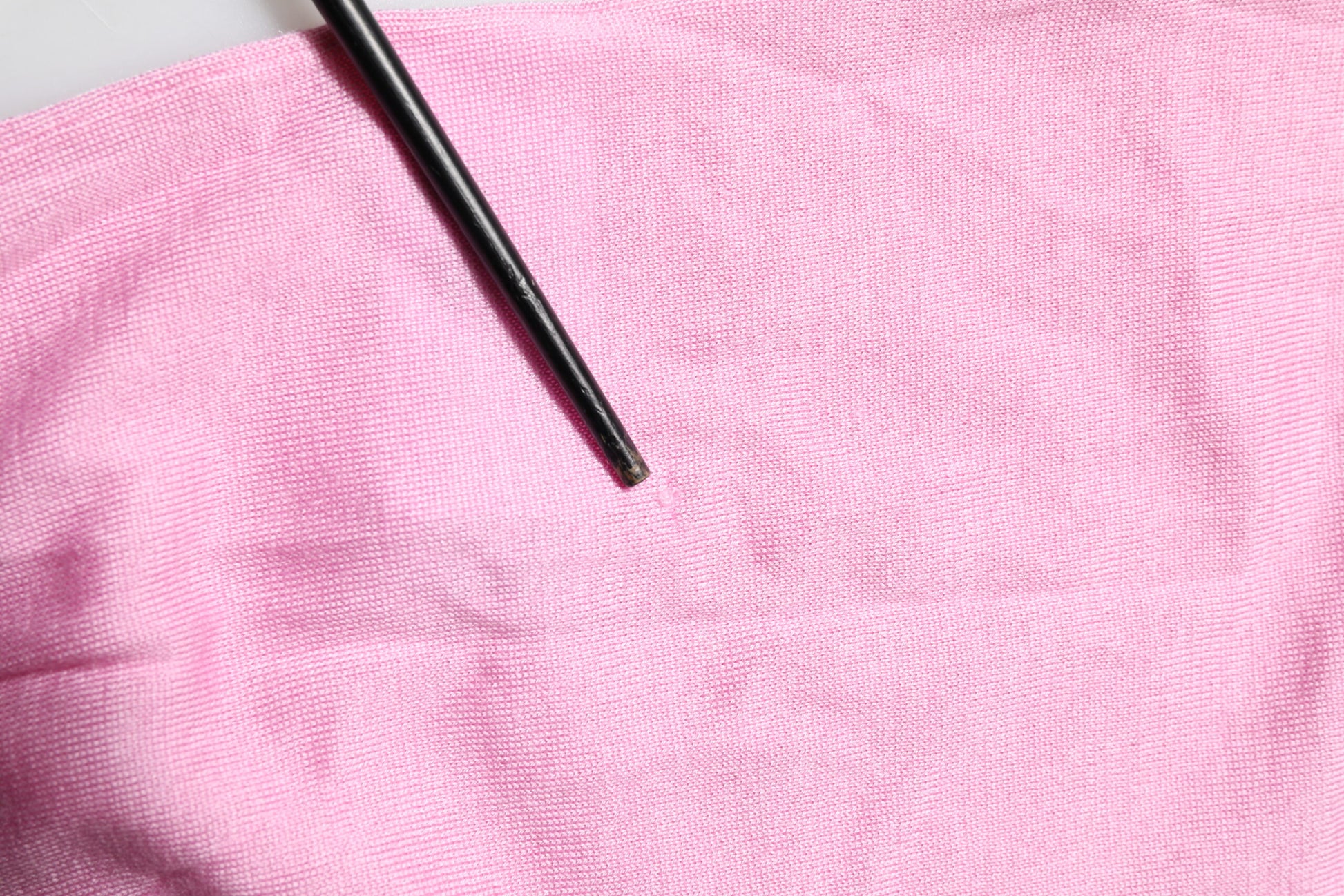 Pink towel with black comb on top
