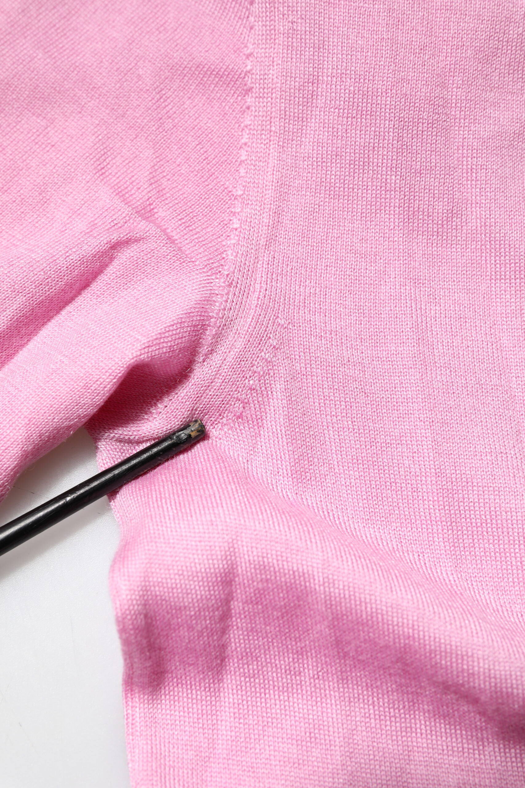Pink knitted fabric with a black marking pen on top