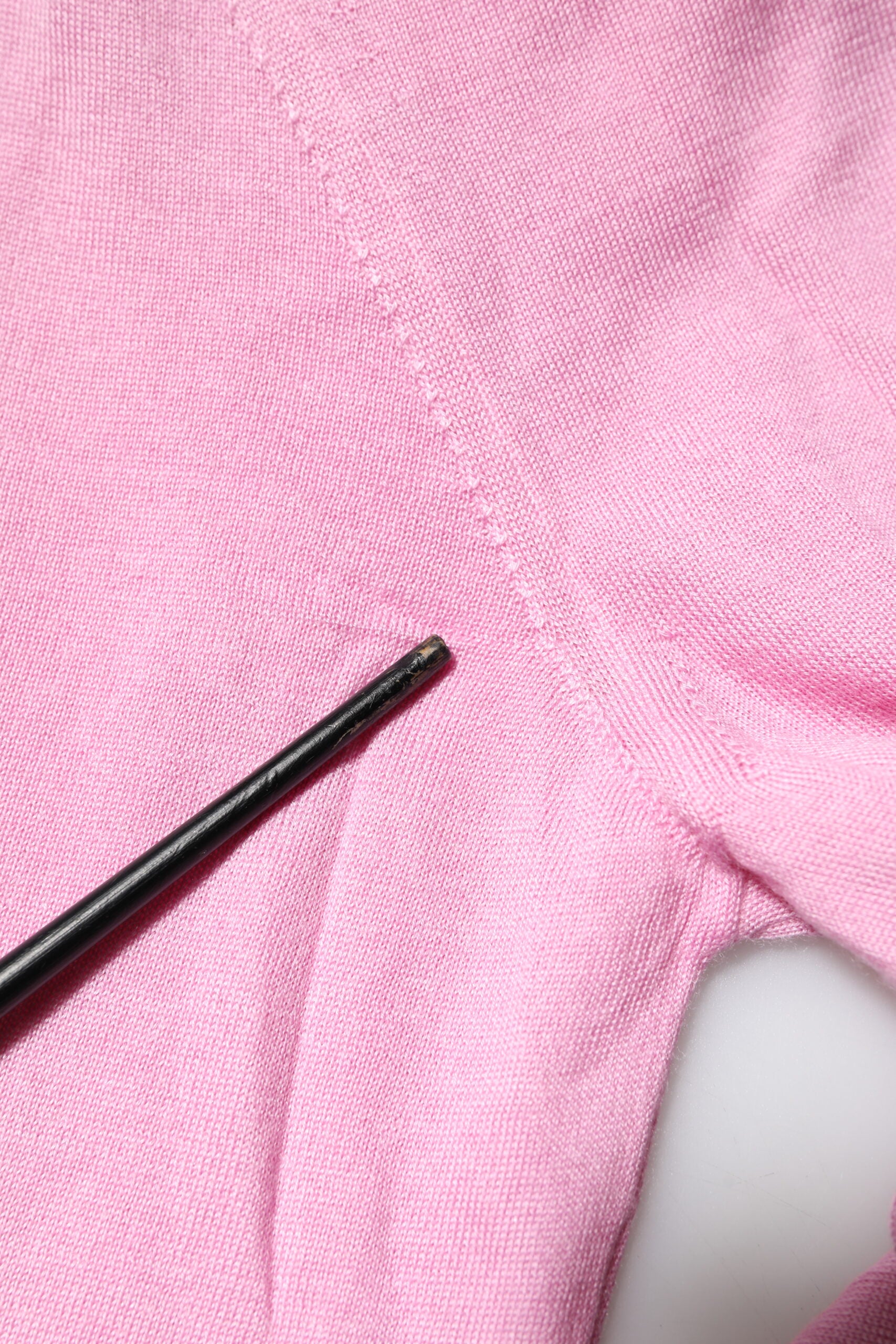 Pink fabric with black needle