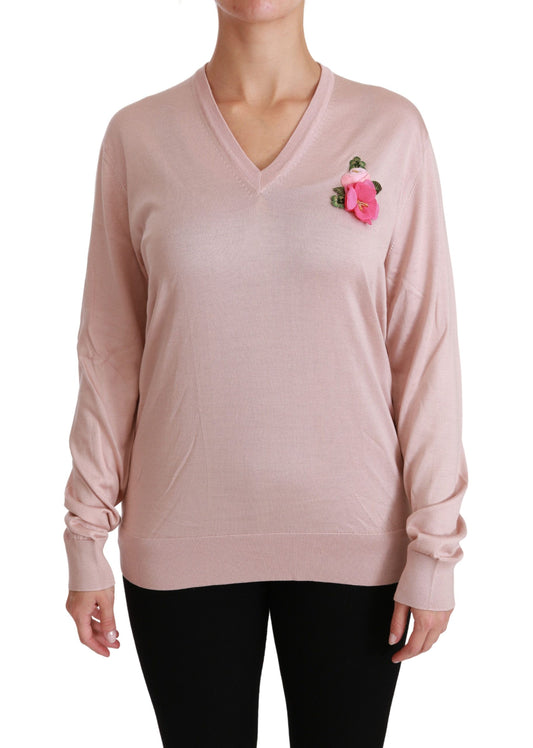 Long sleeve pink sweater with a small pink flower on left side