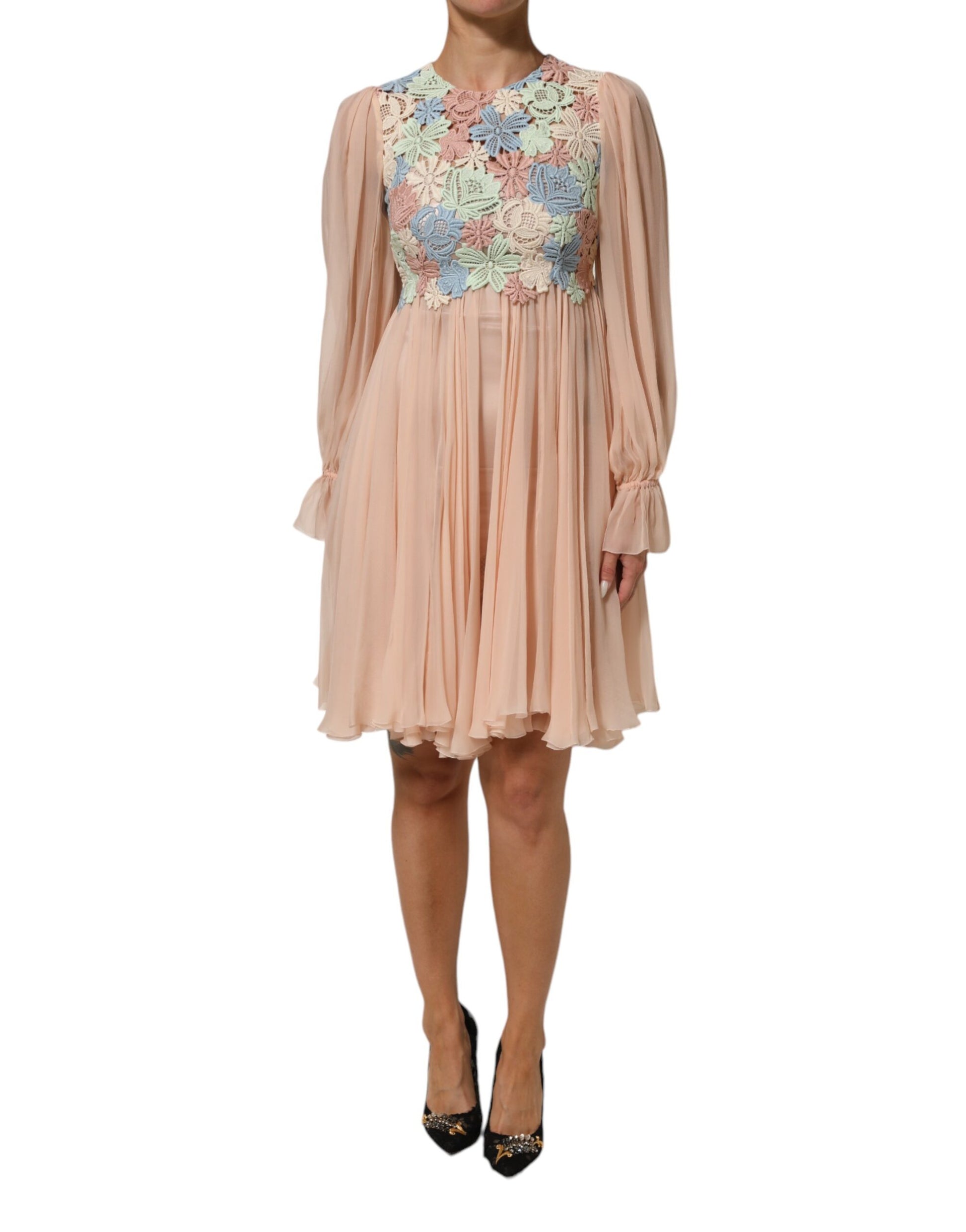 A pink floral embroidered pleated dress with long sleeves