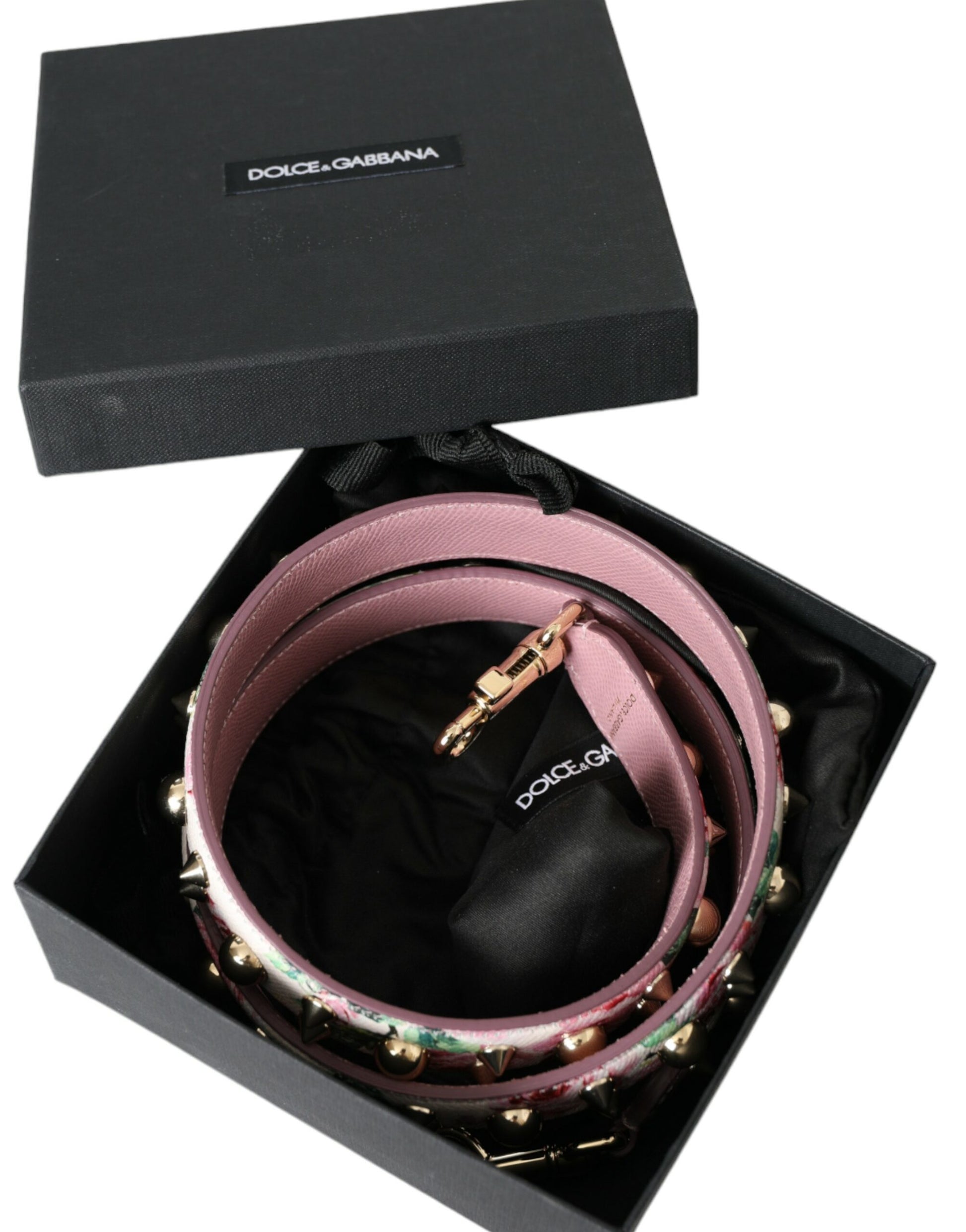 Box containing two bracelets with pink straps and gold accents