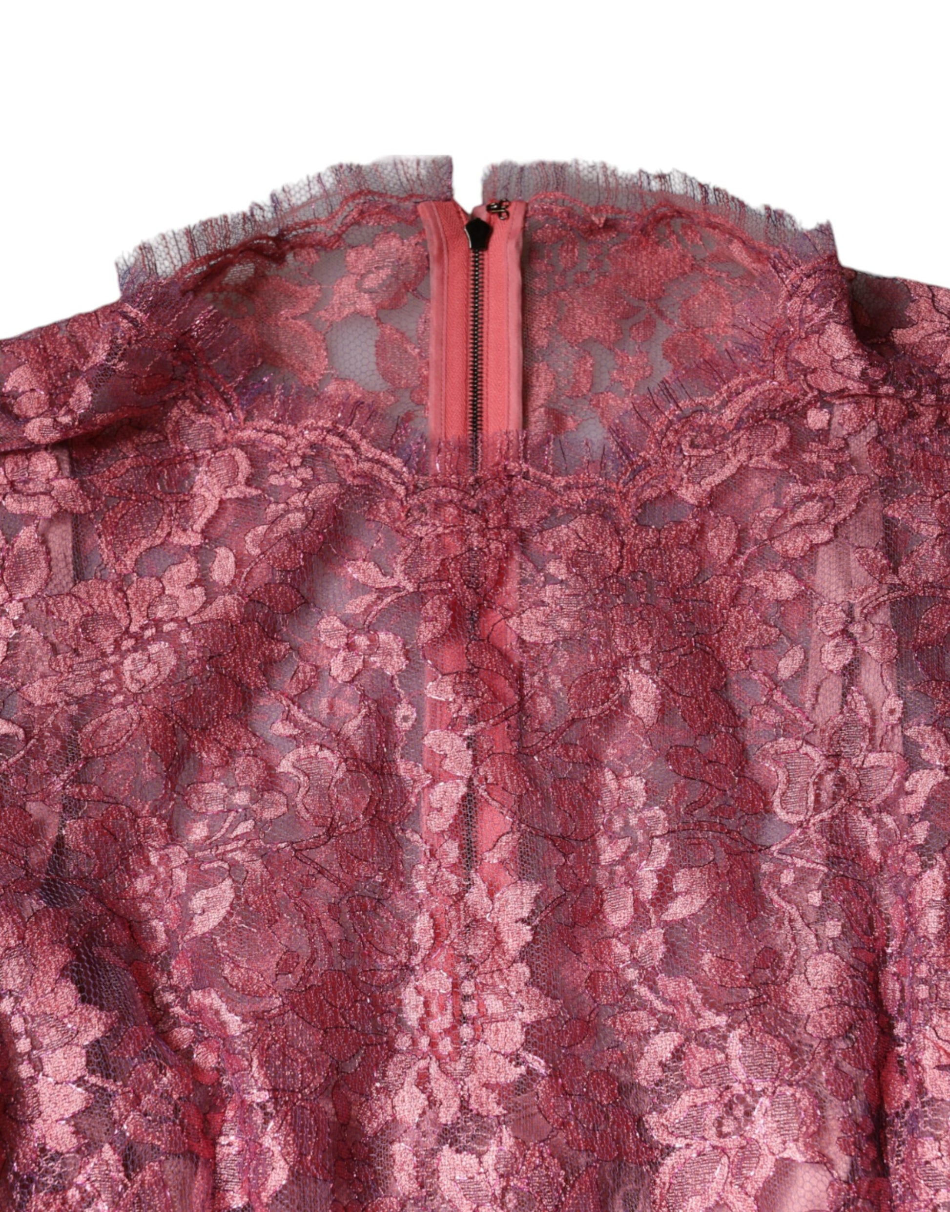 A pink lace midi dress with long sleeves and a floral pattern