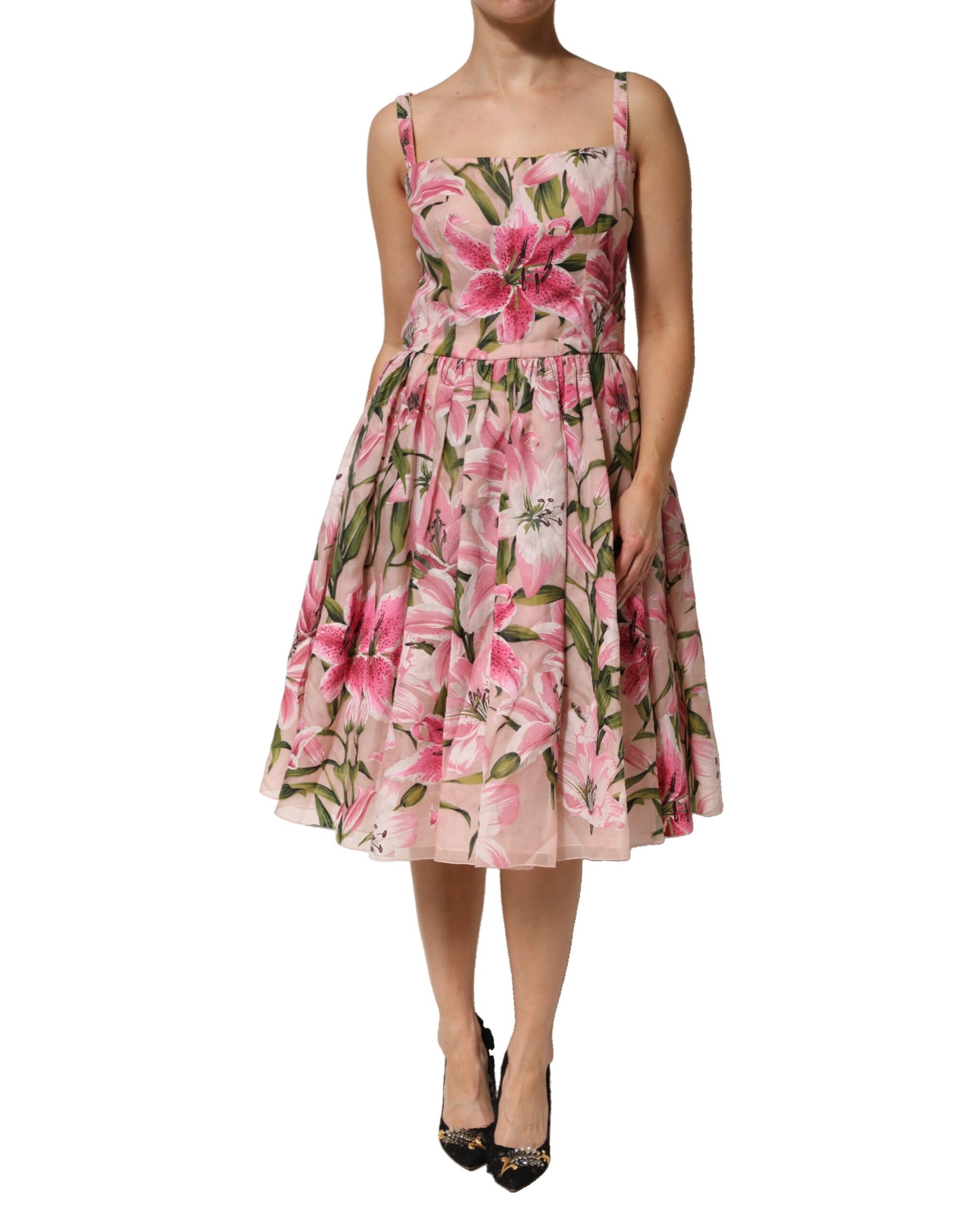 A pink floral midi dress with lily print, sleeveless and knee-length