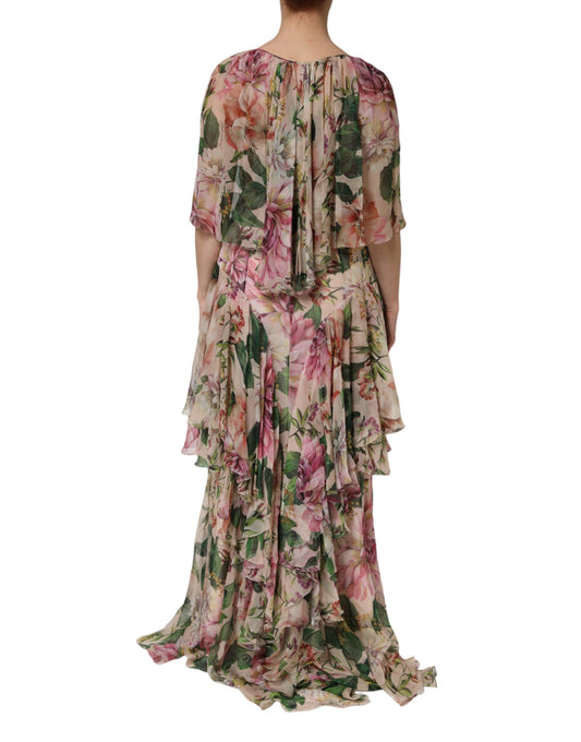 A long pink floral print maxi dress with tiered ruffles and a flowing skirt
