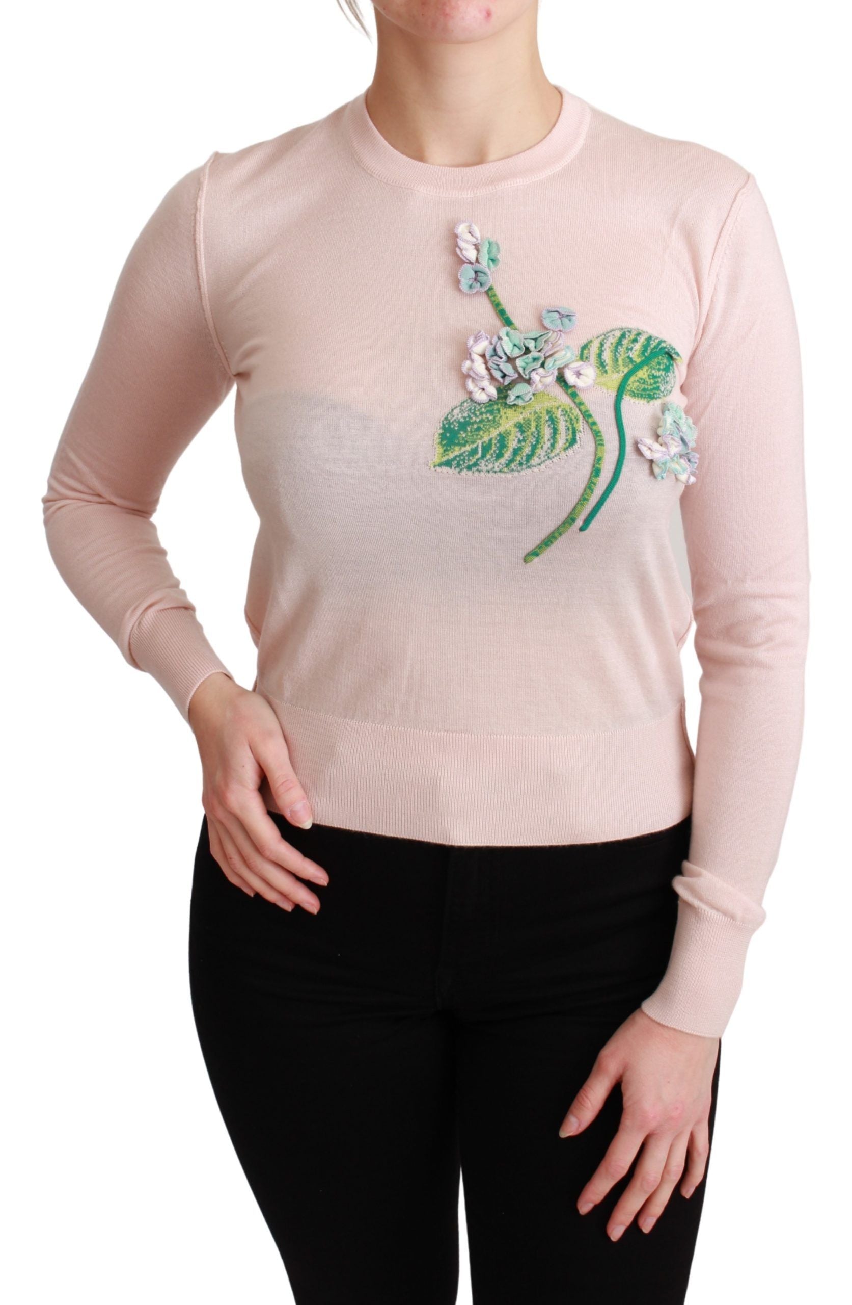 Pink sweater with floral design on front