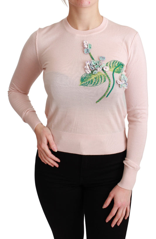 Pink sweater with floral design on front