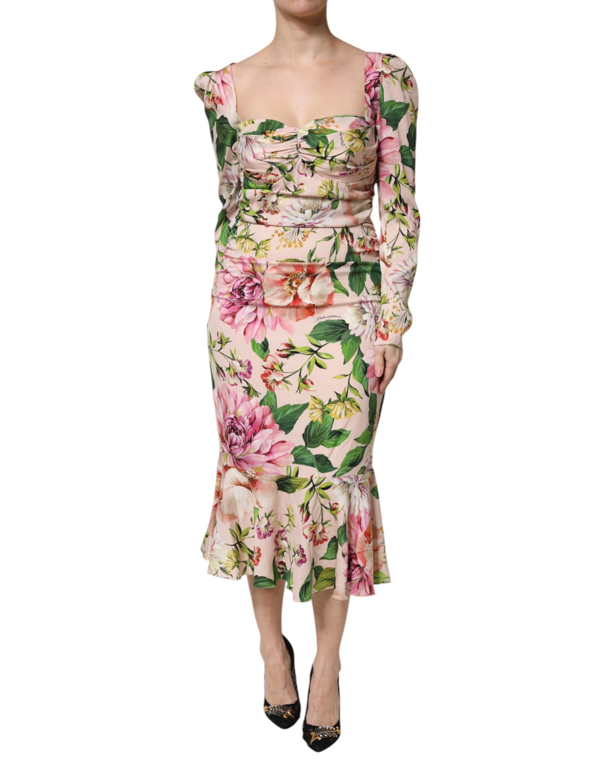 A pink floral midi dress with a fit and flare silhouette