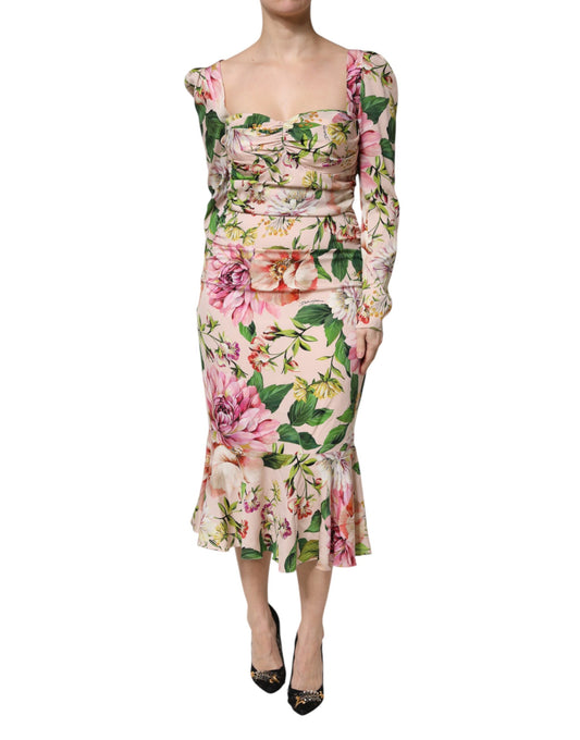 A pink floral midi dress with a fit and flare silhouette