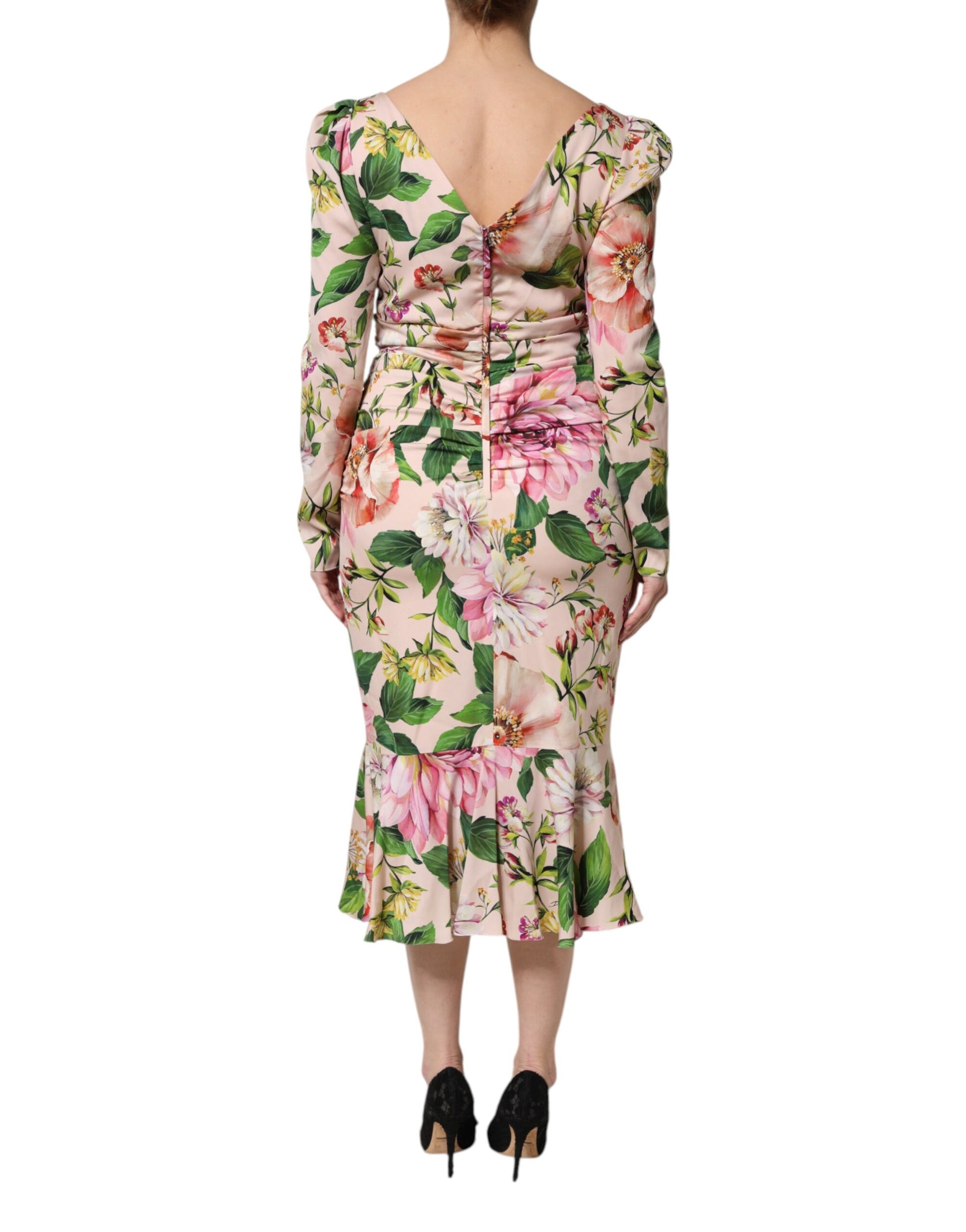 A pink floral midi dress with a silky texture and flared skirt