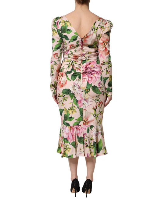 A pink floral midi dress with a silky texture and flared skirt