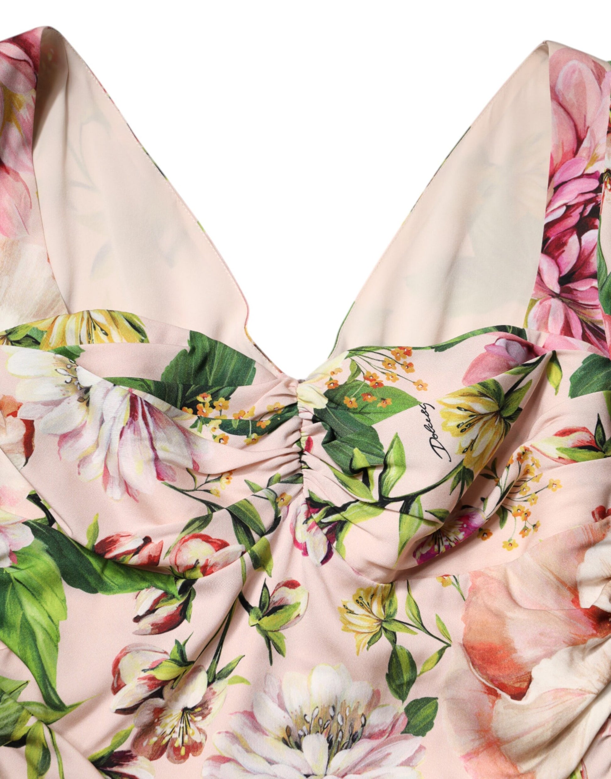 A pink floral silk midi dress with a fit and flare design