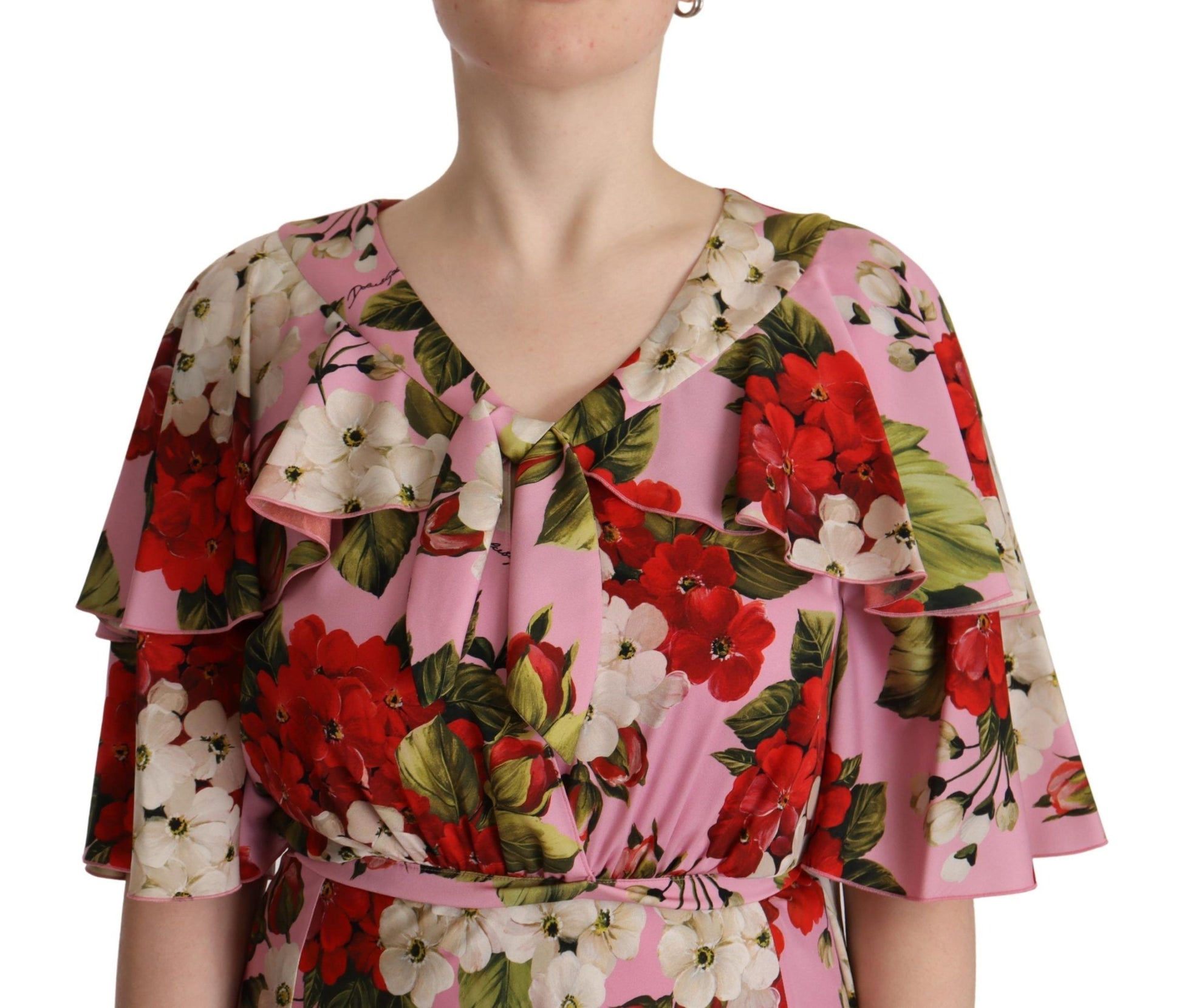 A pink floral silk stretch gown with a V-neckline and ruffled sleeves