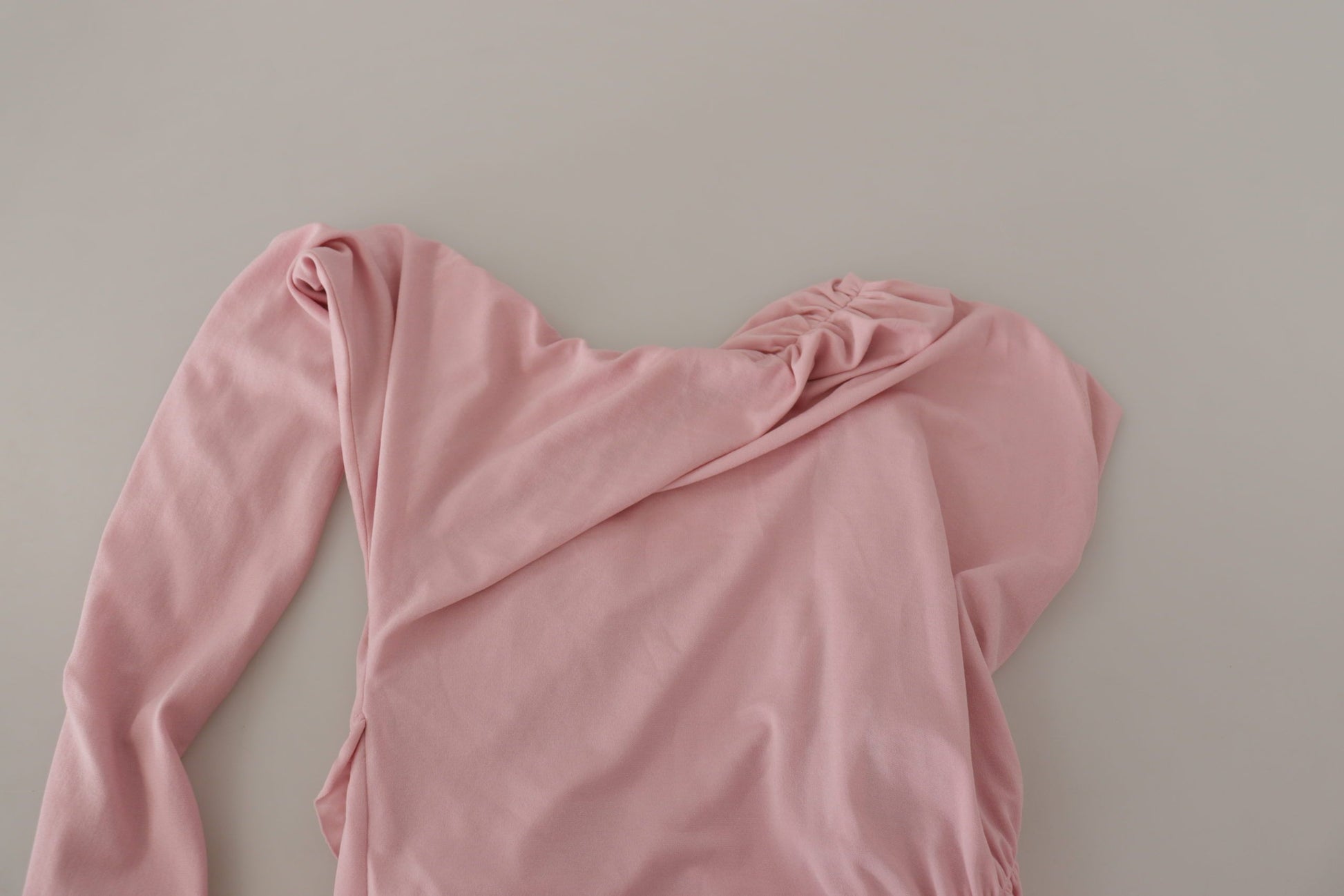Pink long sleeve shirt on table