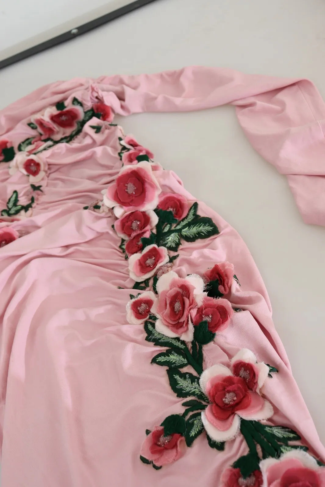 Pink satin dress with floral embroidery on bodice
