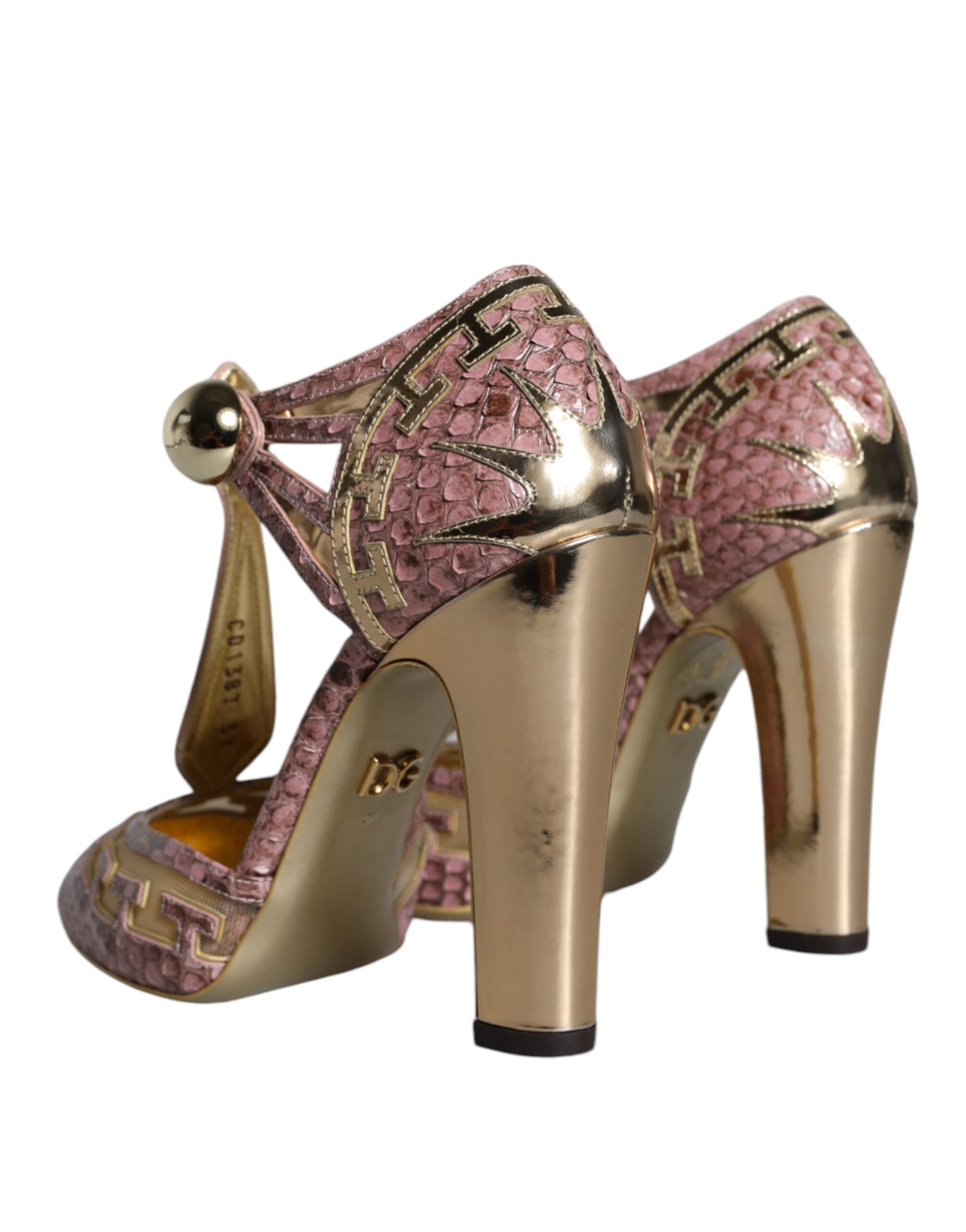 Pair of gold high heel shoes with pink accents
