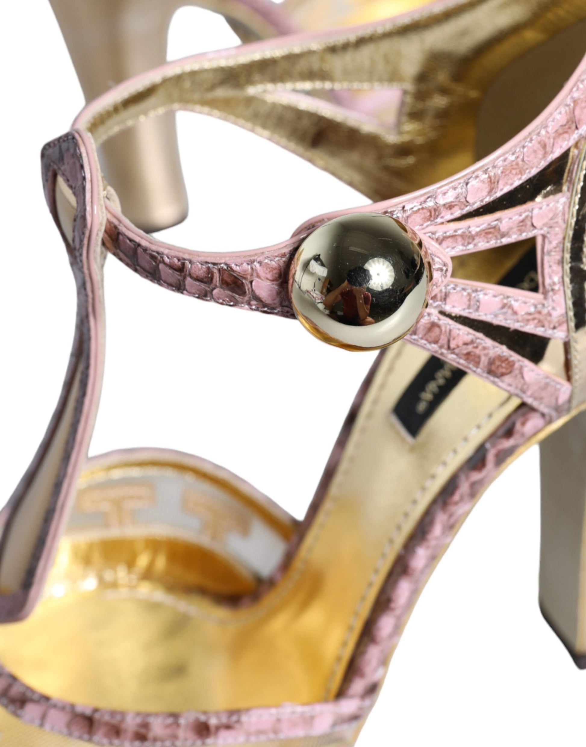High heel shoe with gold accents and pink detailing