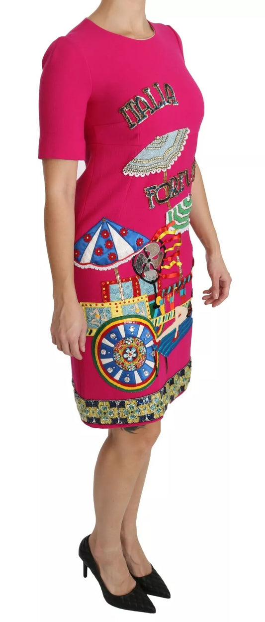 A pink dress with a colorful pattern on the front, featuring crystals and embroidery