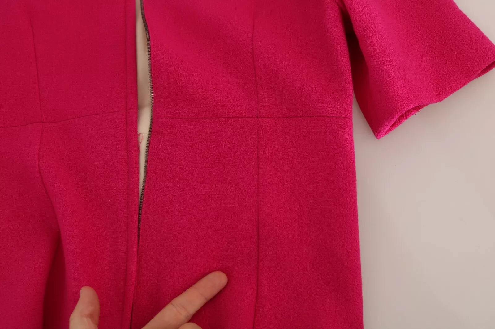A pink crystal sheath dress with a V-neckline and short sleeves