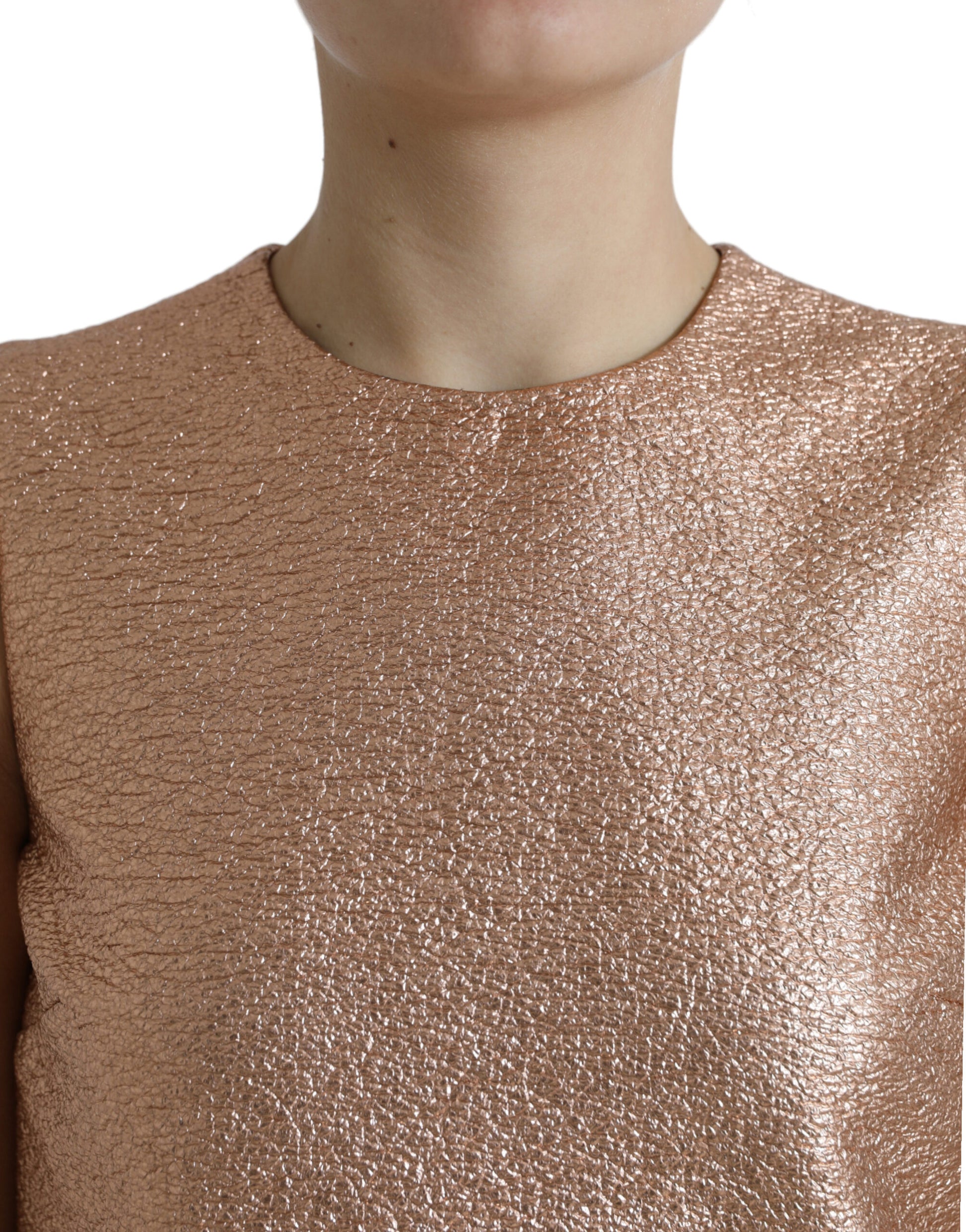 A sleeveless pink jacquard dress with a glittery texture