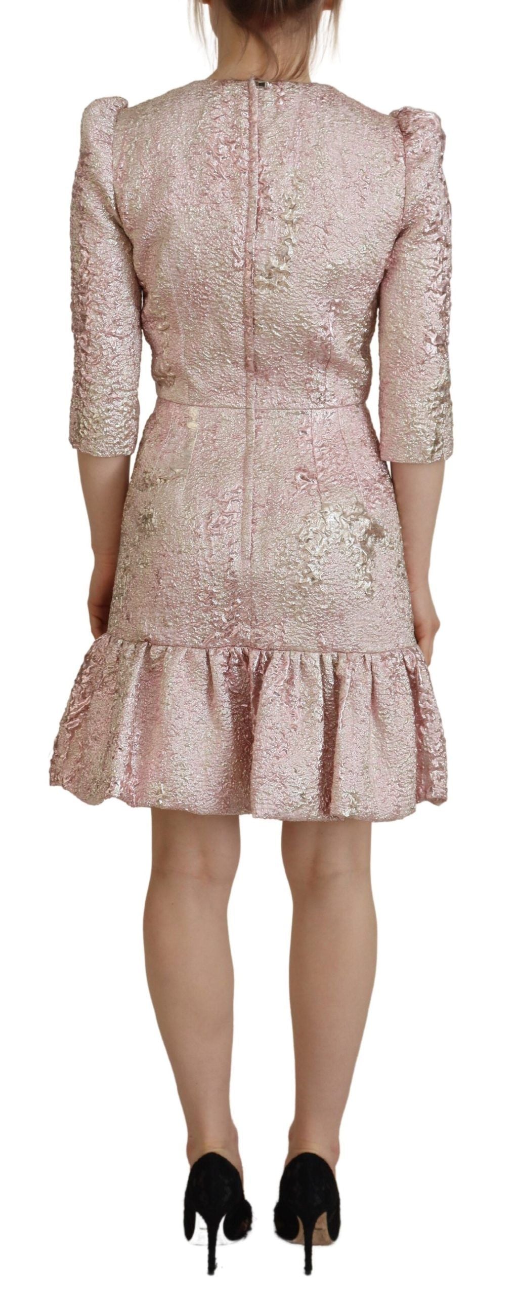 A pink midi dress with a ruffled hem and sleeves