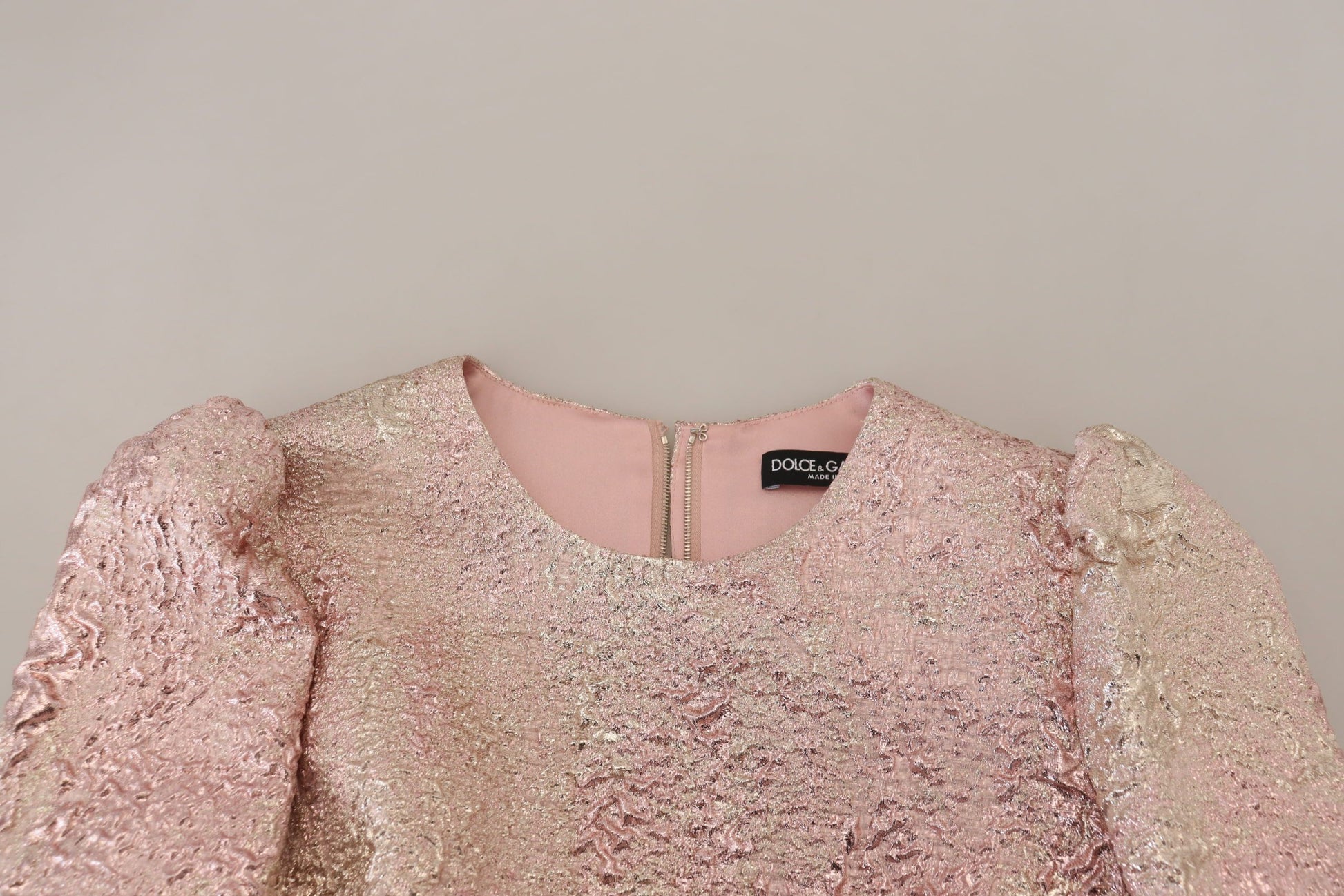A pink glittery dress with a zipper in the front