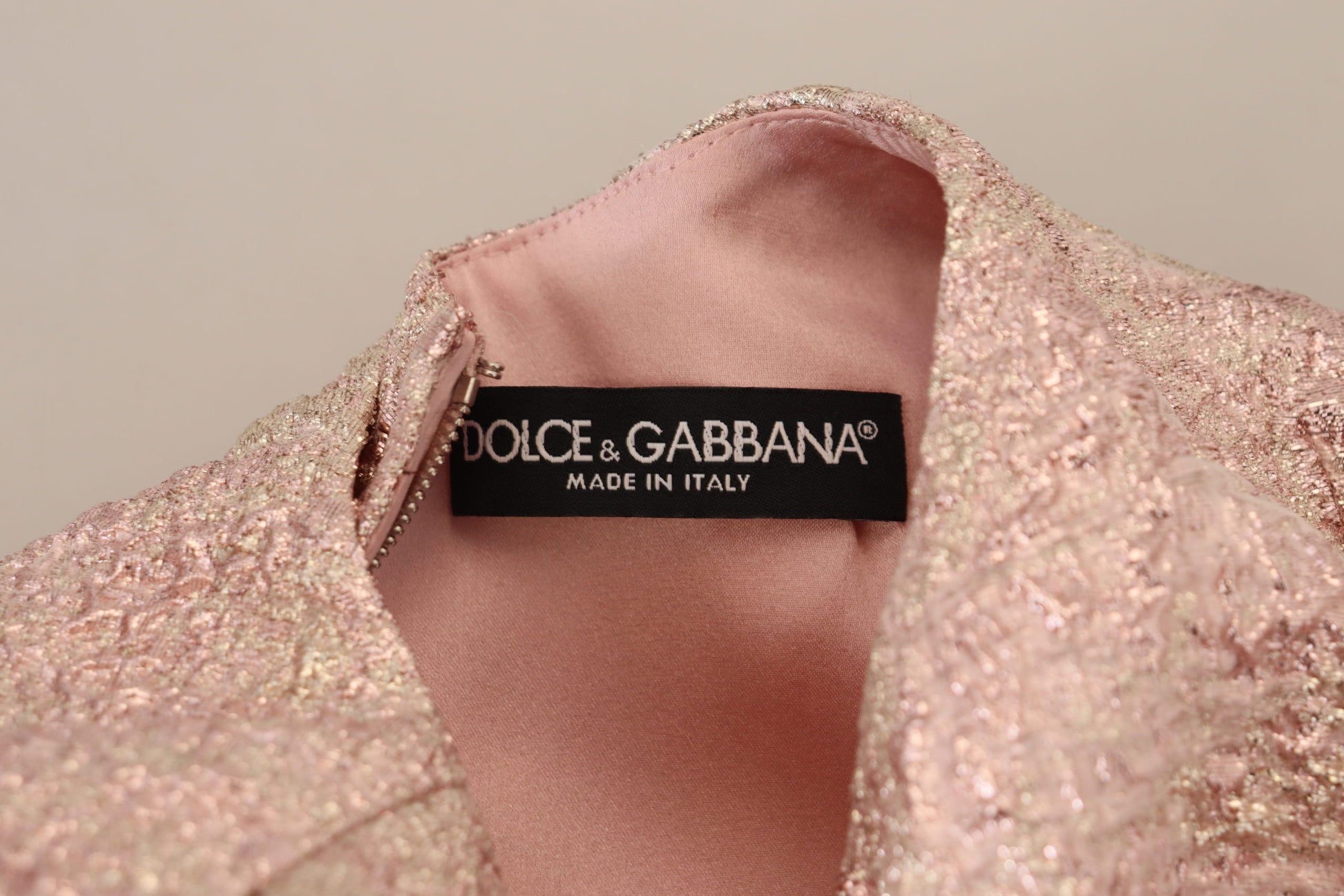 A pink glittery dress with a label that reads "Dolce & Gabbana Made in Italy"