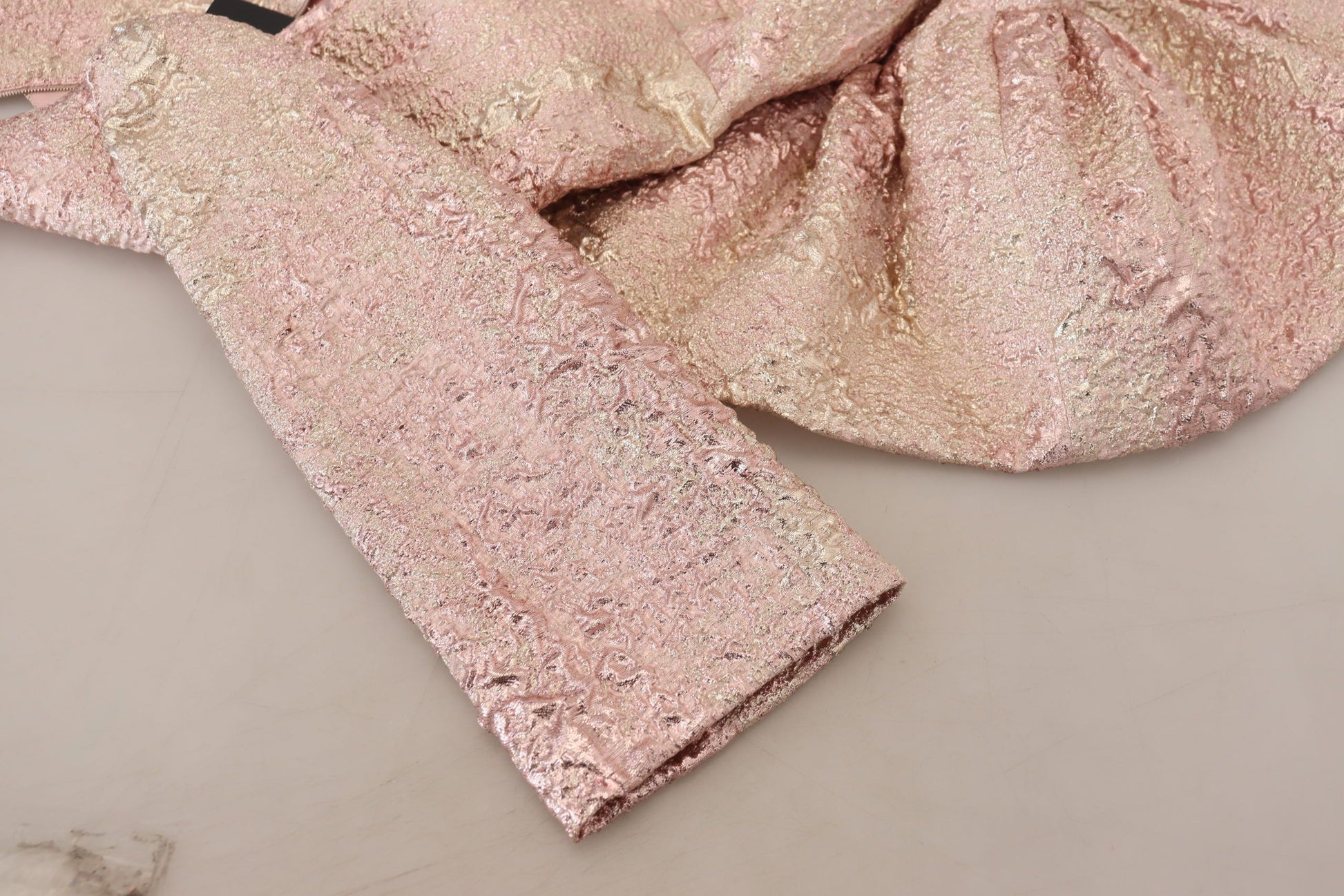 A pink glittery dress with a sheath silhouette and 3/4 sleeves