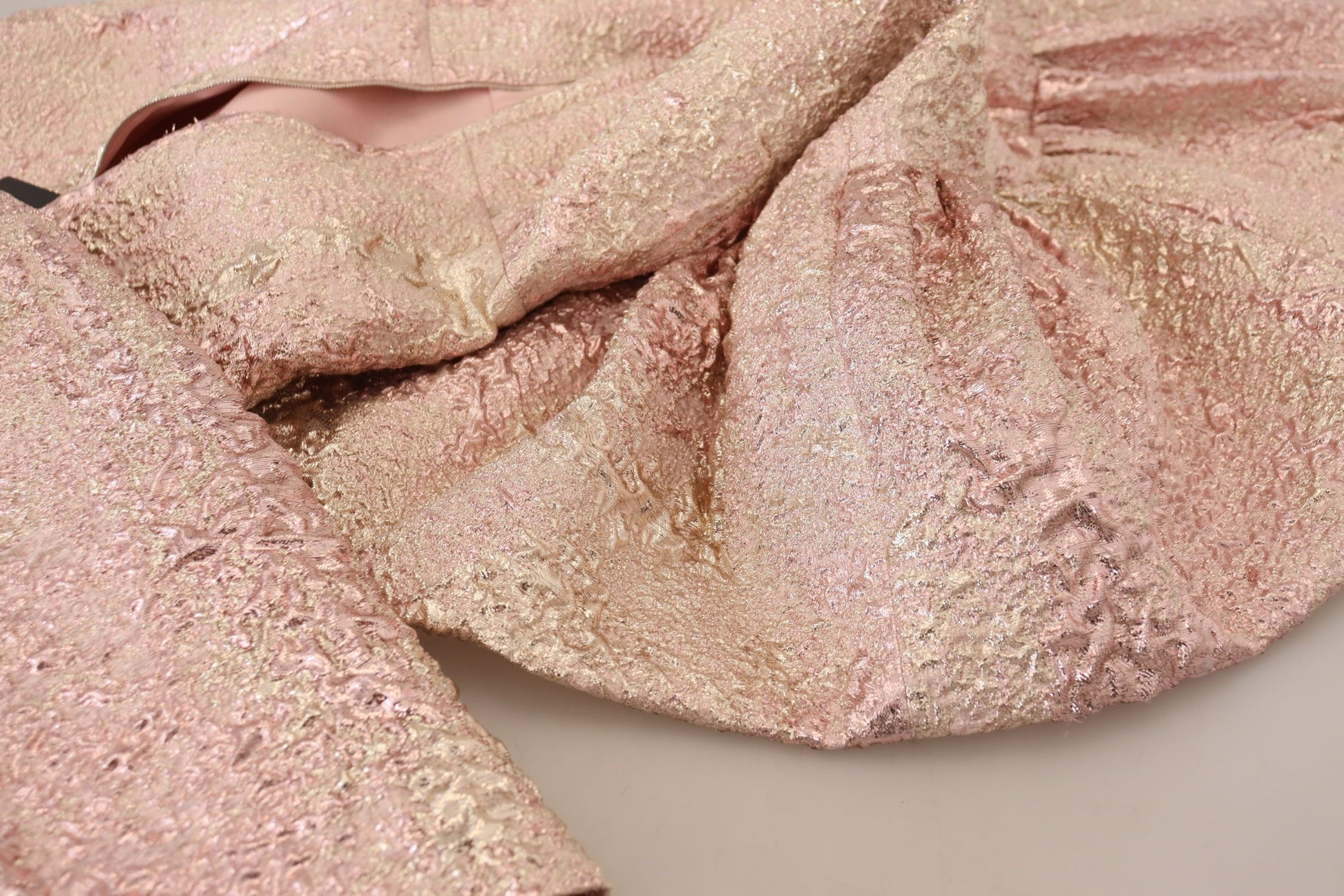 A pink glittery dress with a sheer texture