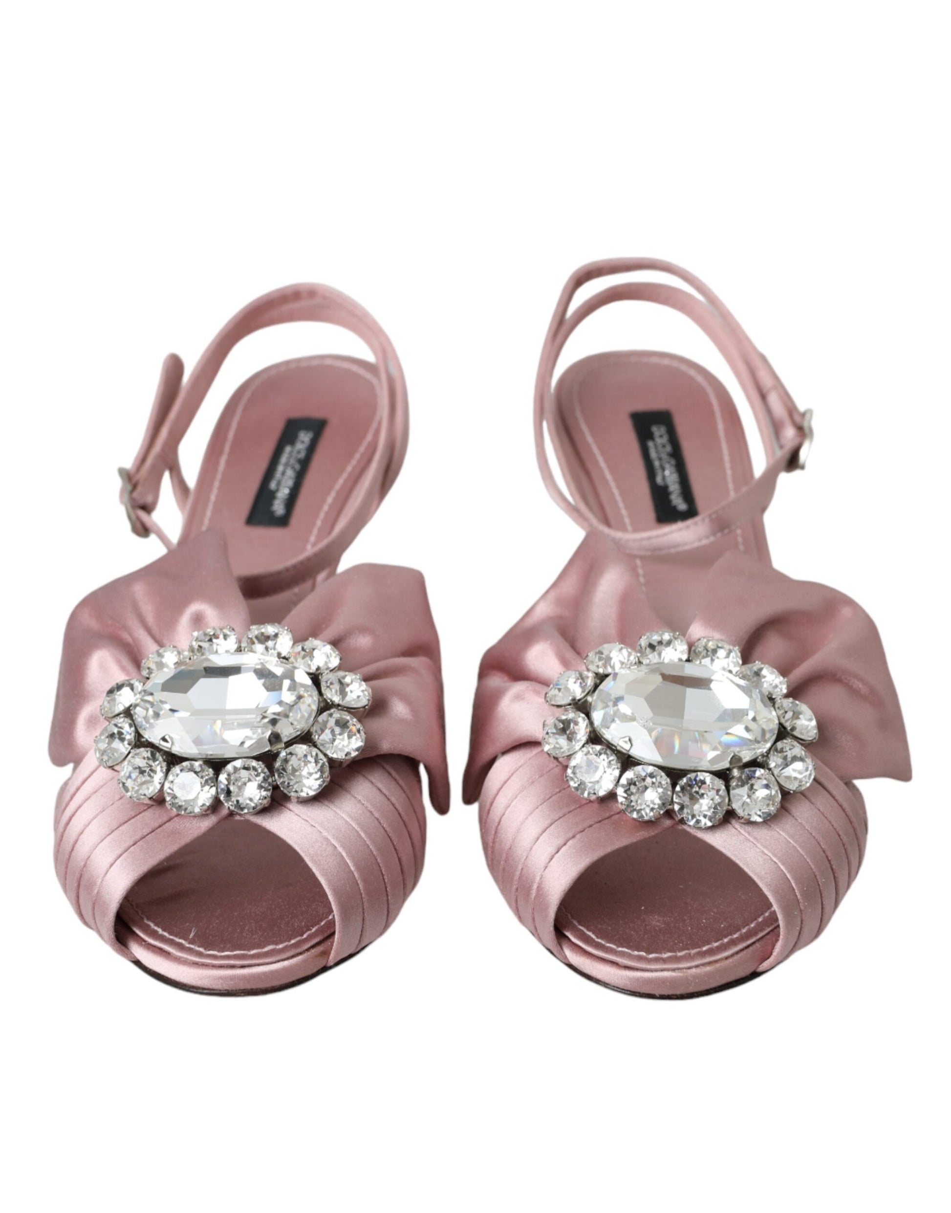 Pair of pink strappy sandals with rhinestone embellishments on toes