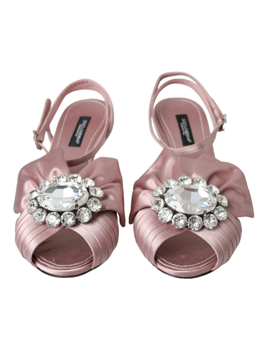 Pair of pink strappy sandals with rhinestone embellishments on toes