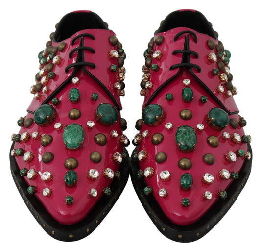 Pair of red shoes with multiple embellishments including jewels and stones