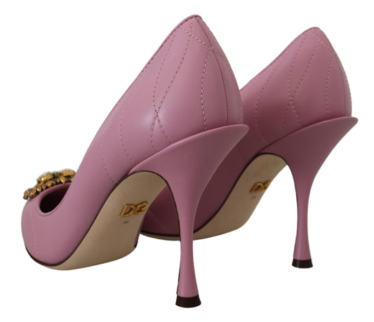 Pair of pink high heel shoes with gold accents