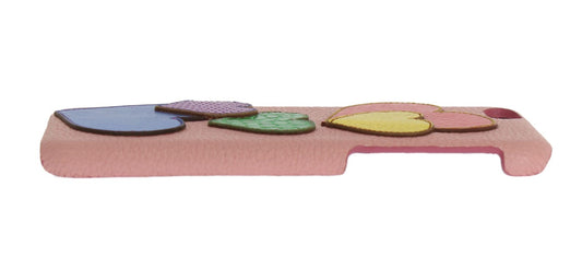 Pink plastic tray with four round cutouts for cookies