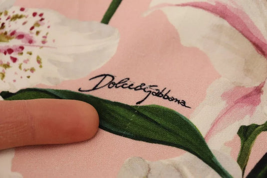 A pink lily patterned knee length dress by Dolce & Gabbana