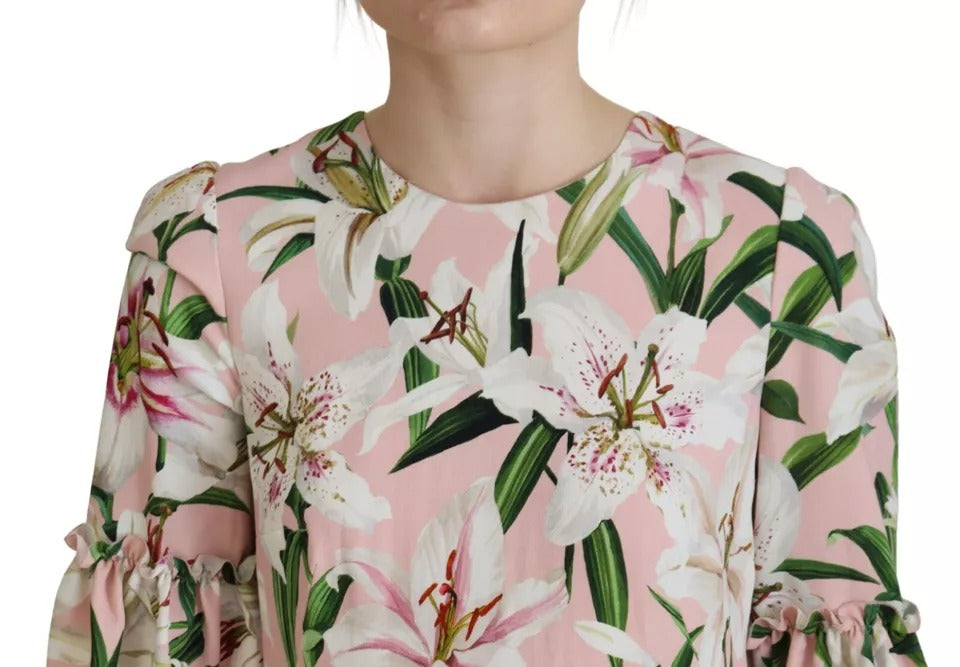 A pink floral dress with long sleeves and a knee length