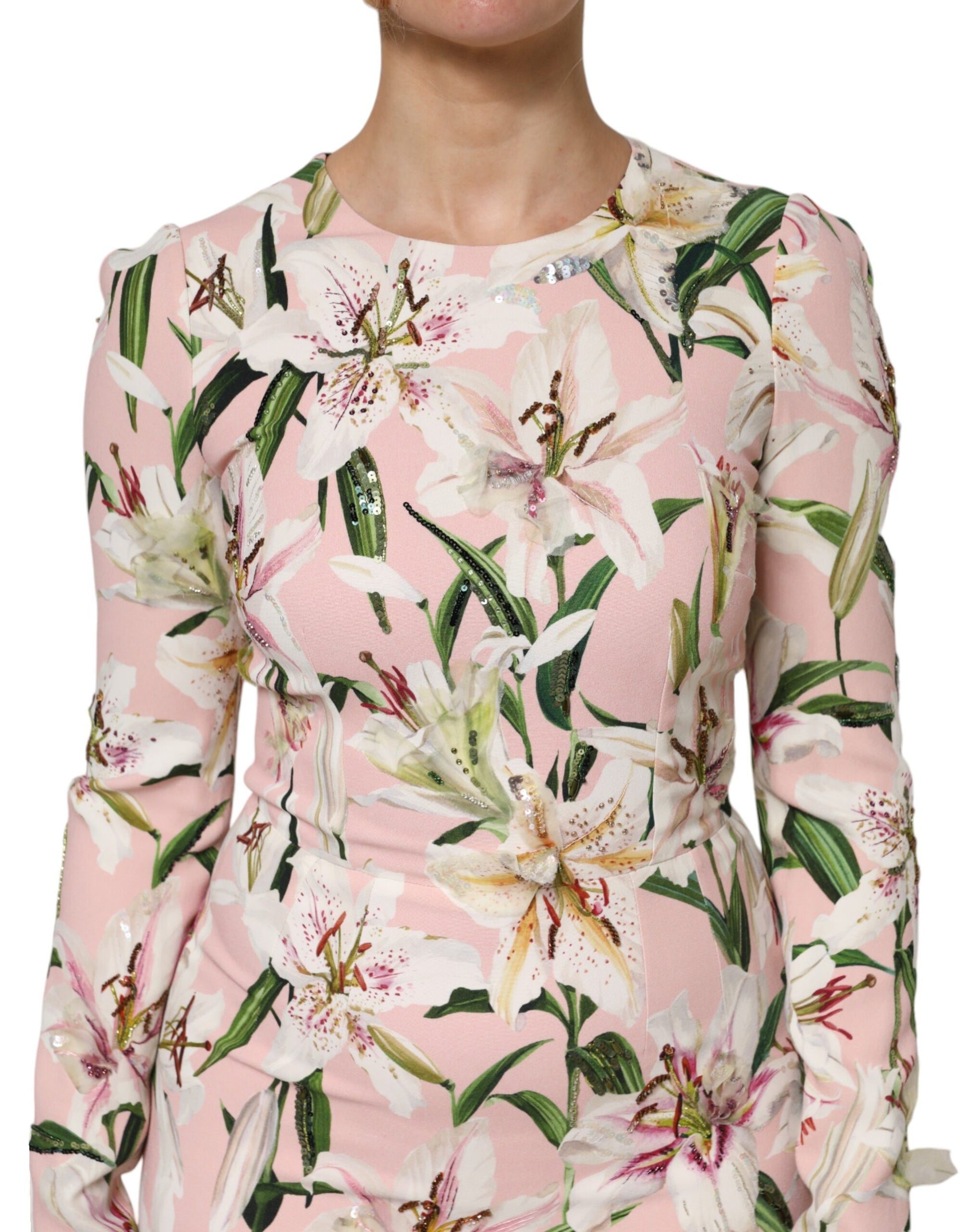 A pink floral midi dress with long sleeves and a sheath silhouette