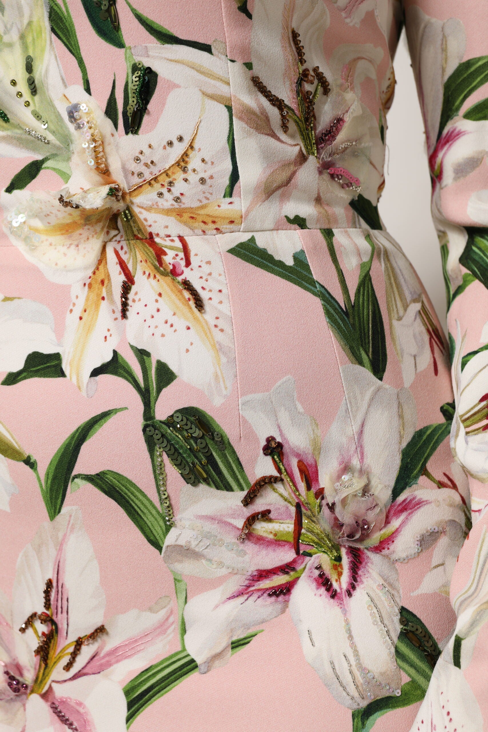 A pink midi dress with lily print and stretchy fabric, designed by Dolce & Gabbana