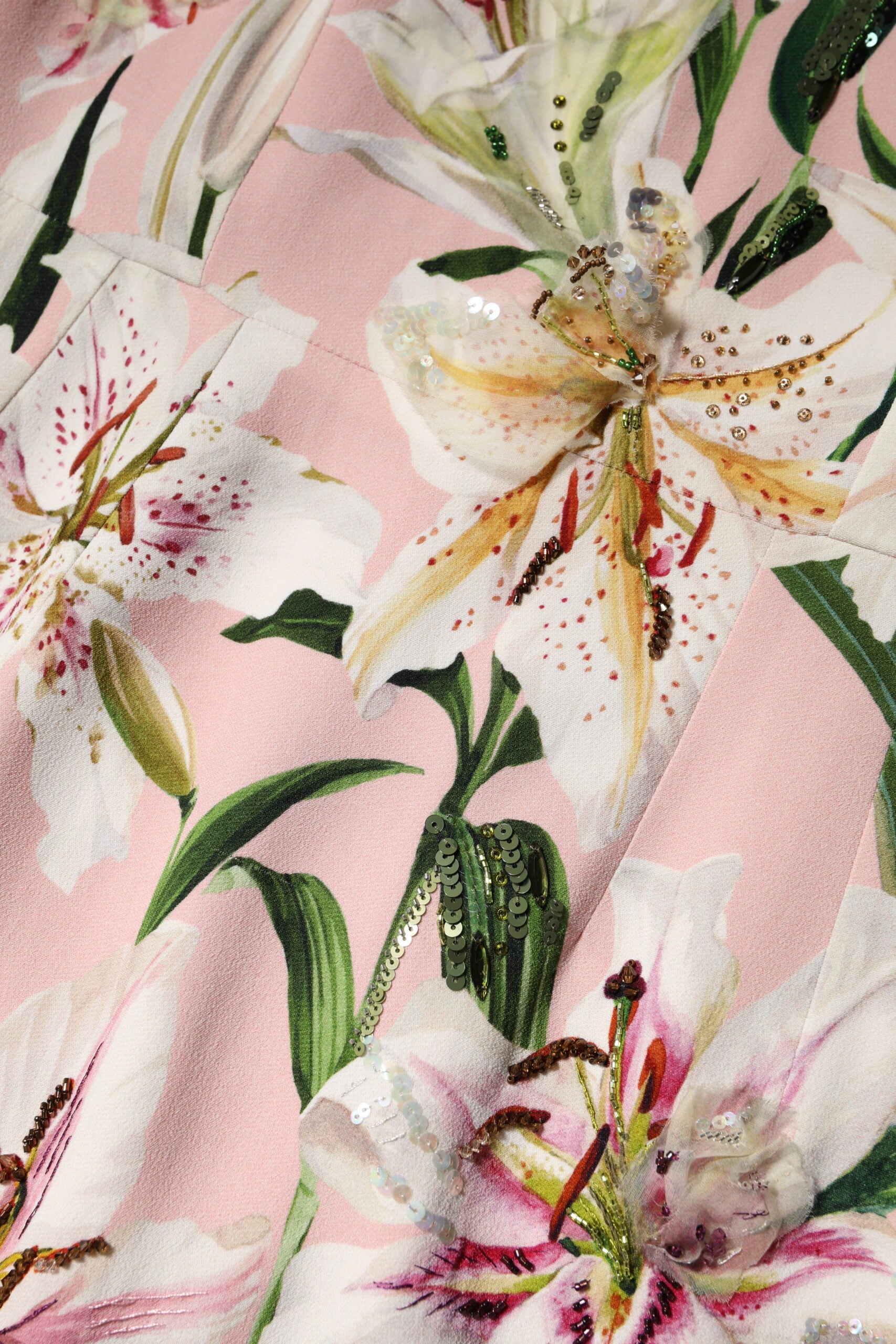 A pink midi dress with lily print and sequins, made of viscose