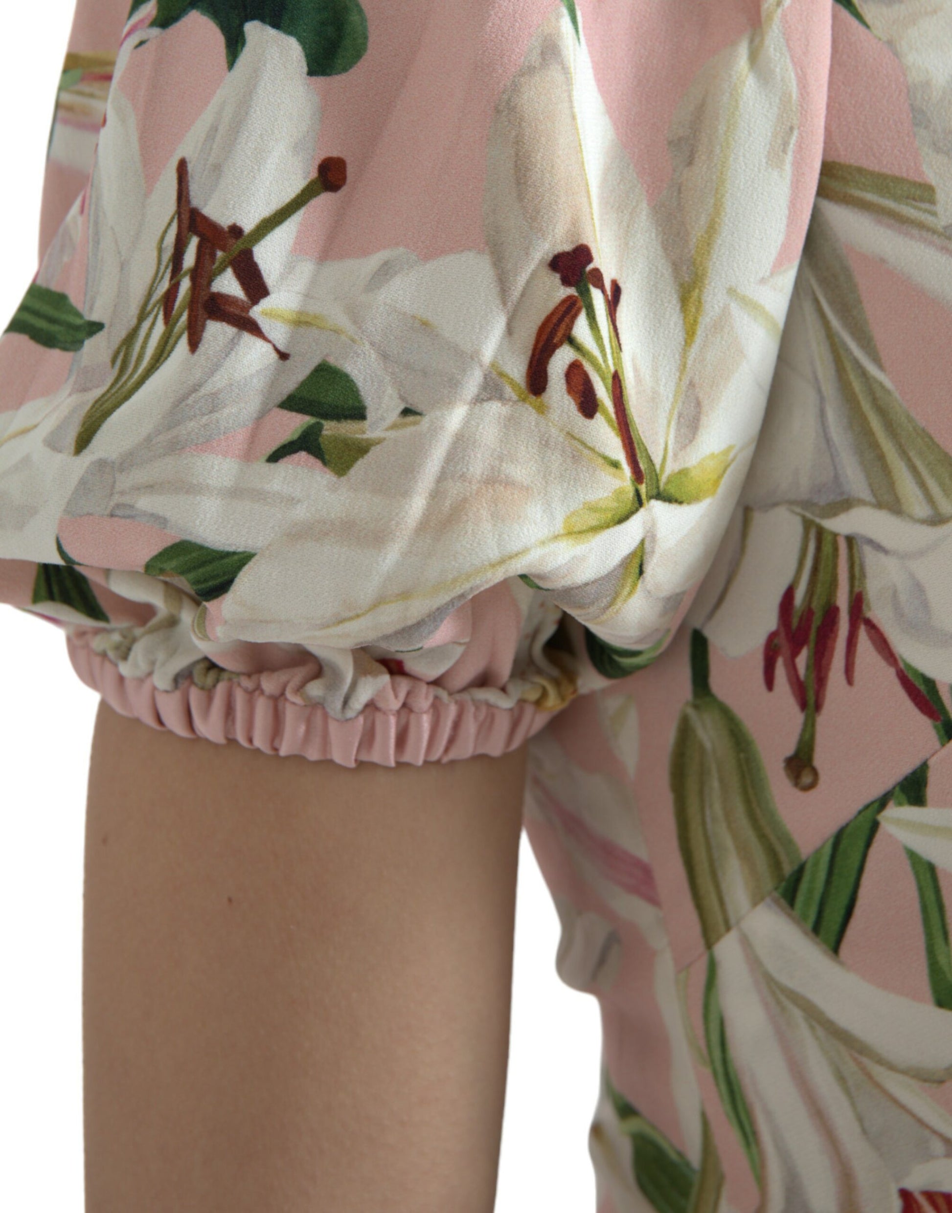 A pink floral sheath dress with ruffled sleeves and hem