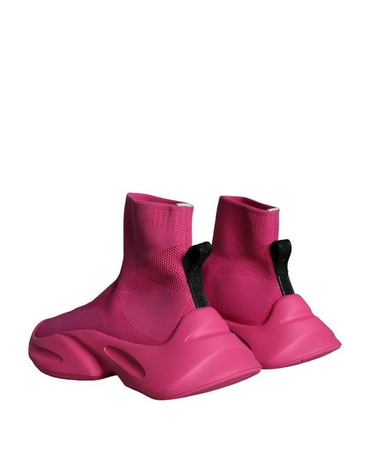 Pair of pink snow boots with black straps and buckles