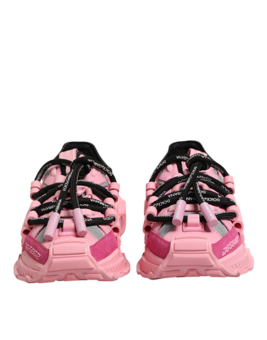 Pair of pink women's sneakers with black laces and a low top design
