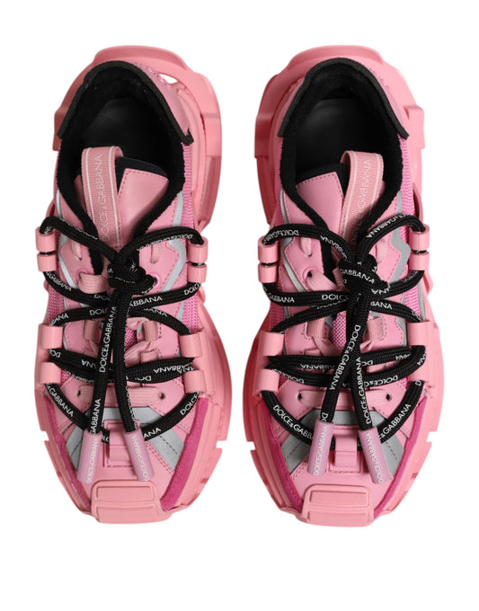 Pair of pink women's sneakers with laces and a logo on the side