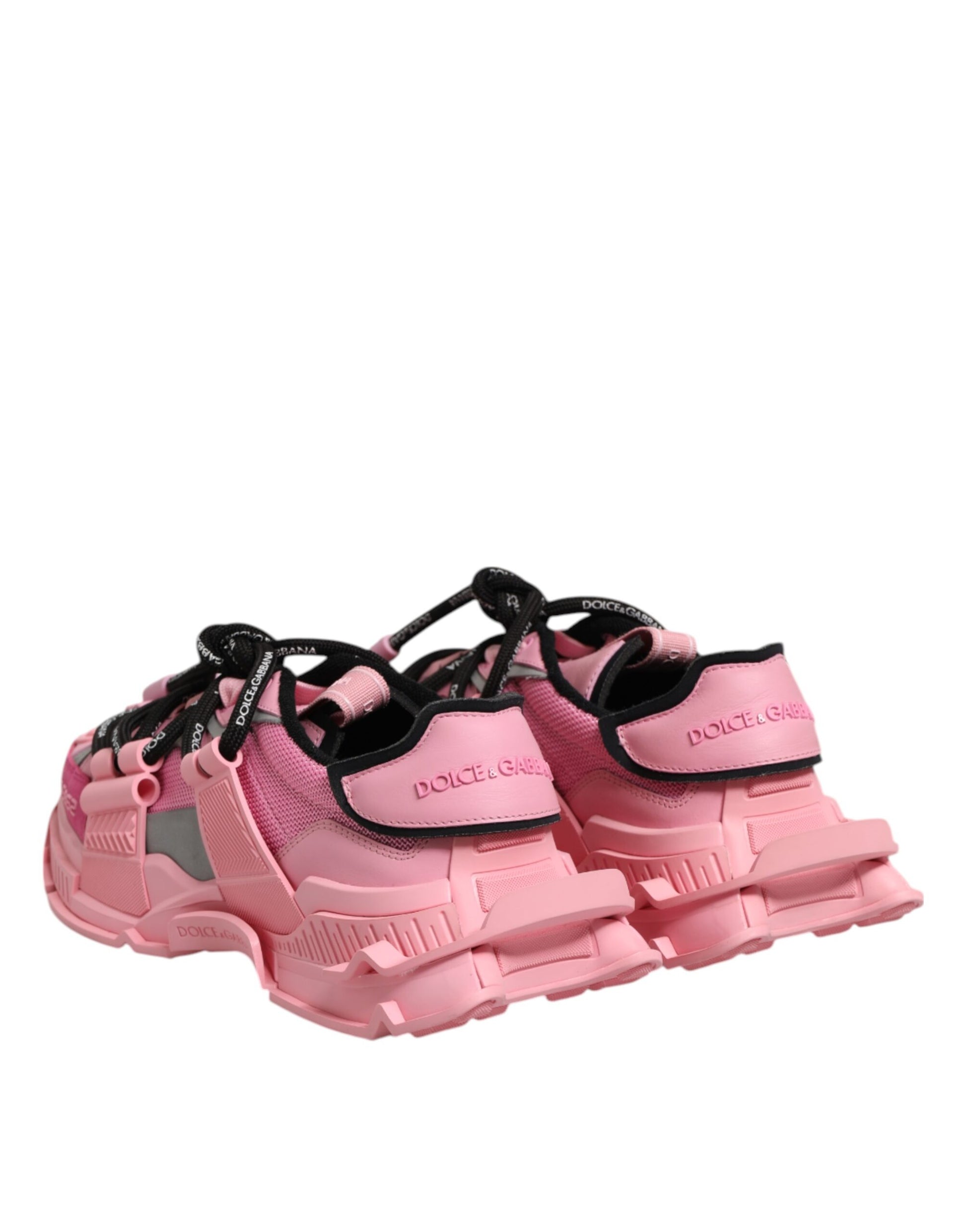 Pair of pink women's sneakers with black laces and logo on side
