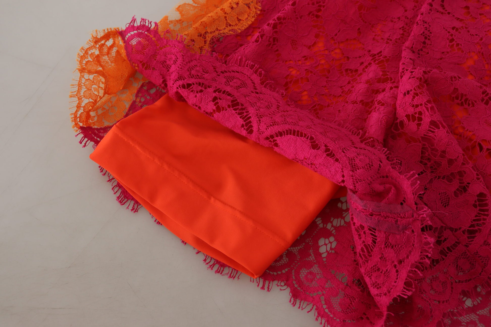 Red lace fabric on white surface