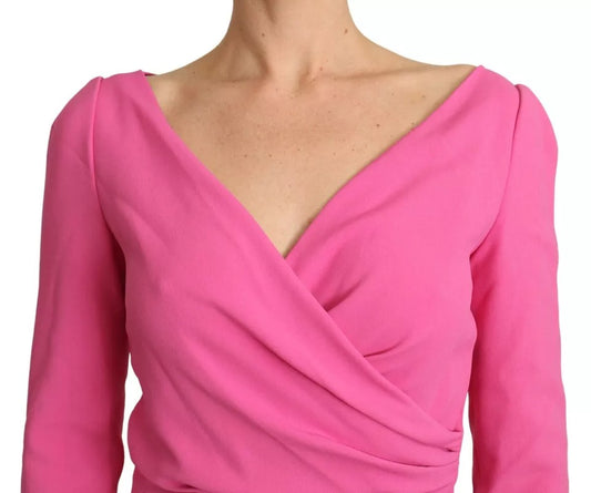 A pink plunging bodycon sheath mini dress with a V-neckline