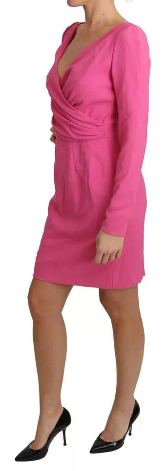 A pink bodycon dress with a plunging neckline and short sleeves