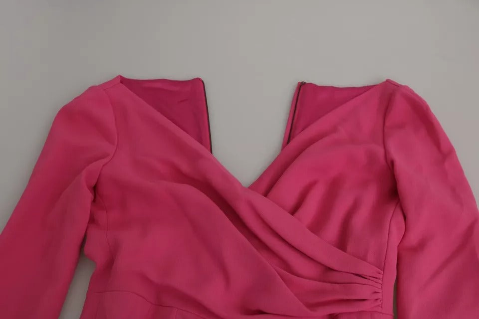 A pink bodycon dress with plunging neckline and short sleeves